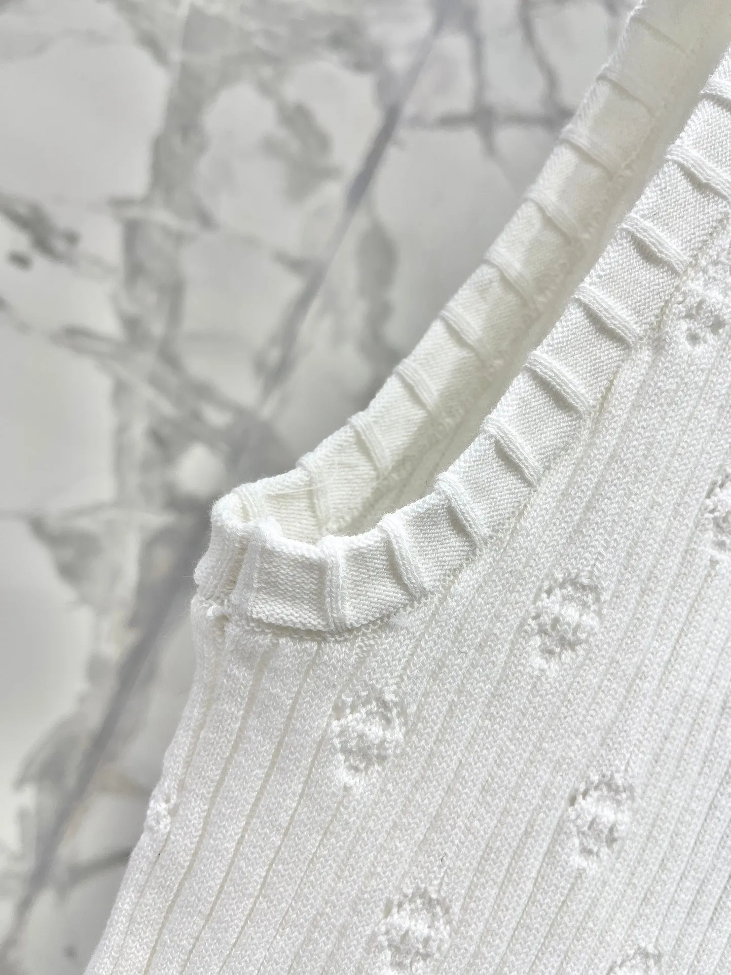Hollow knitted vest with perforations